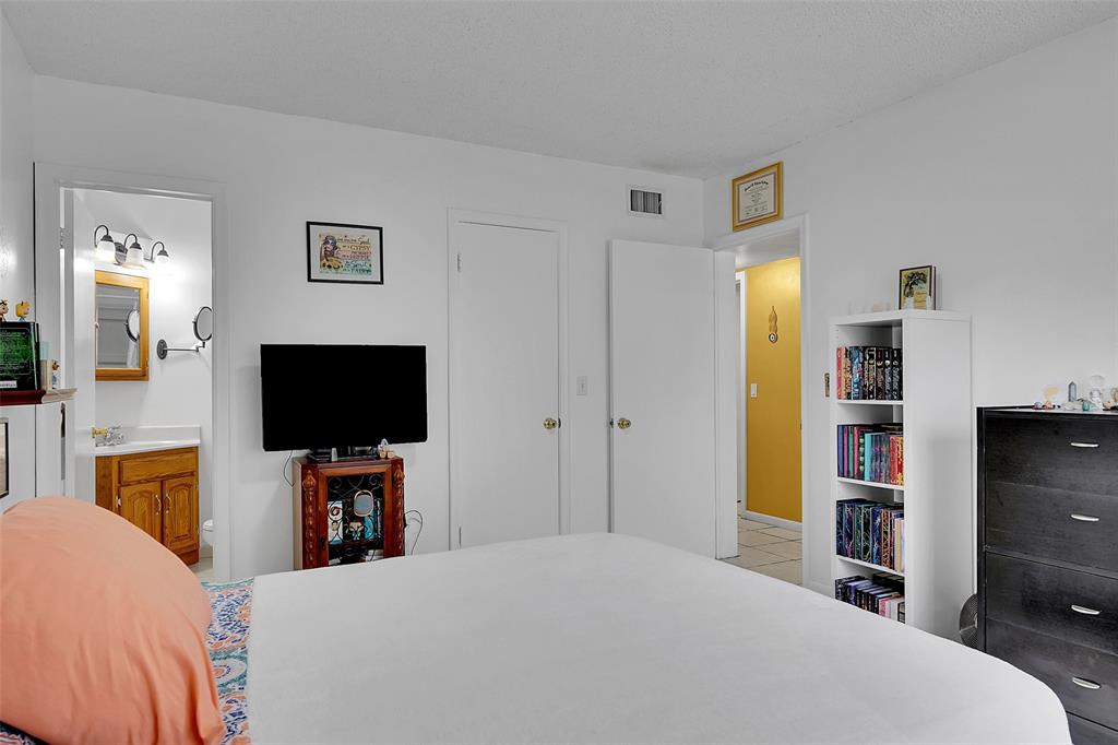 330 South Cypress Road, Unit 610 Pompano Beach, FL 33060 - Photo 16 of 35 a bedroom with a bed and a flat screen tv