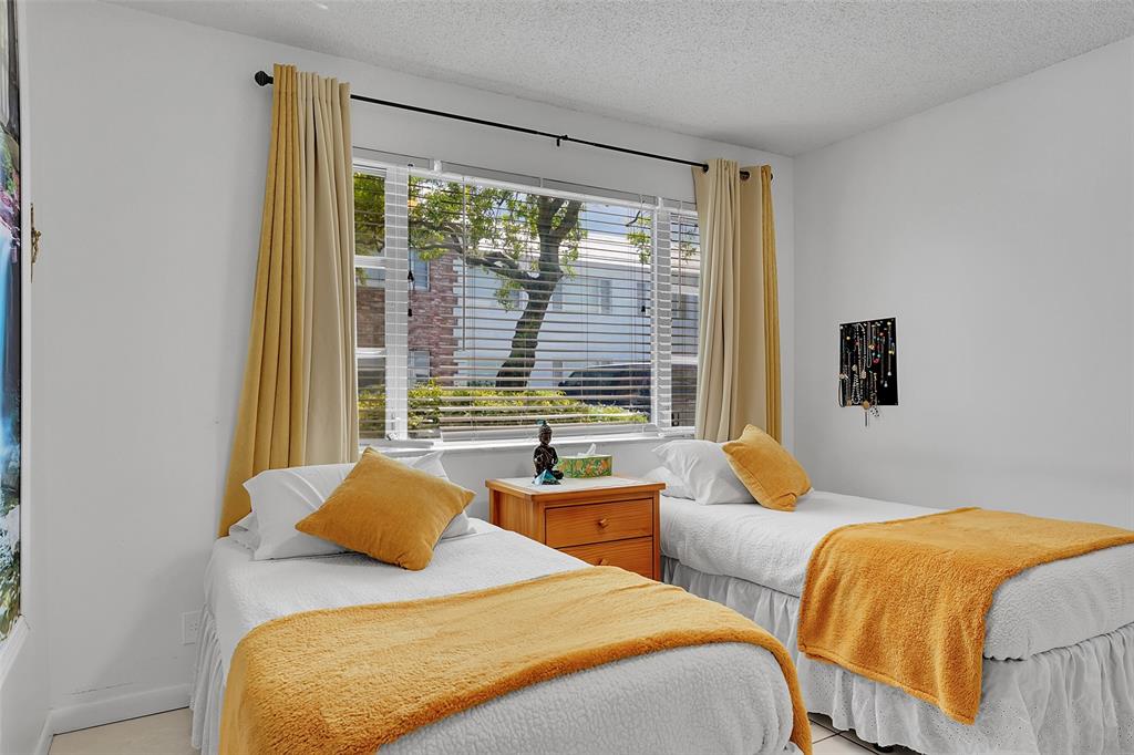 330 South Cypress Road, Unit 610 Pompano Beach, FL 33060 - Photo 20 of 35 a bedroom with two beds and a large window