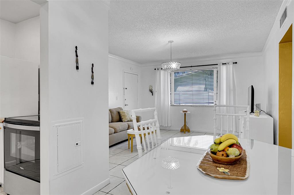 330 South Cypress Road, Unit 610 Pompano Beach, FL 33060 - Photo 2 of 35 a living room with furniture and a window