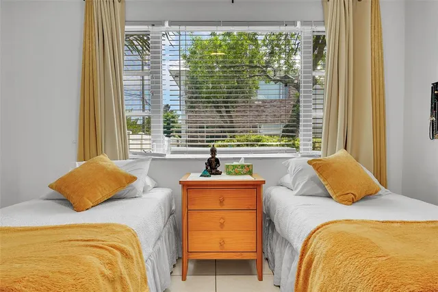 a bedroom with a bed and a window with outer view