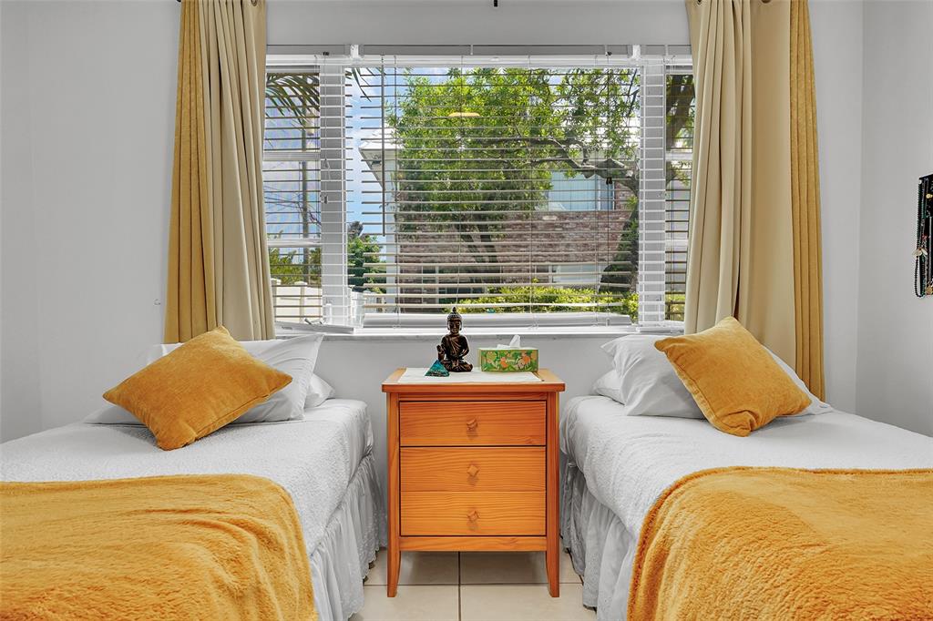 330 South Cypress Road, Unit 610 Pompano Beach, FL 33060 - Photo 21 of 35 a bedroom with a bed and a window with outer view