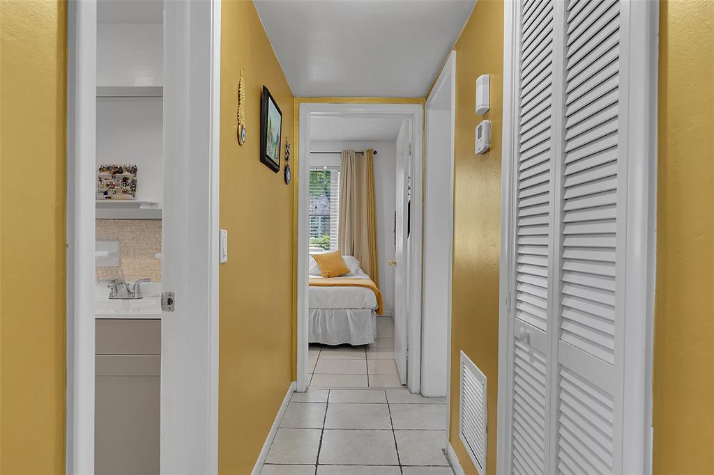 330 South Cypress Road, Unit 610 Pompano Beach, FL 33060 - Photo 22 of 35 a view of a hallway with bathroom and bathroom
