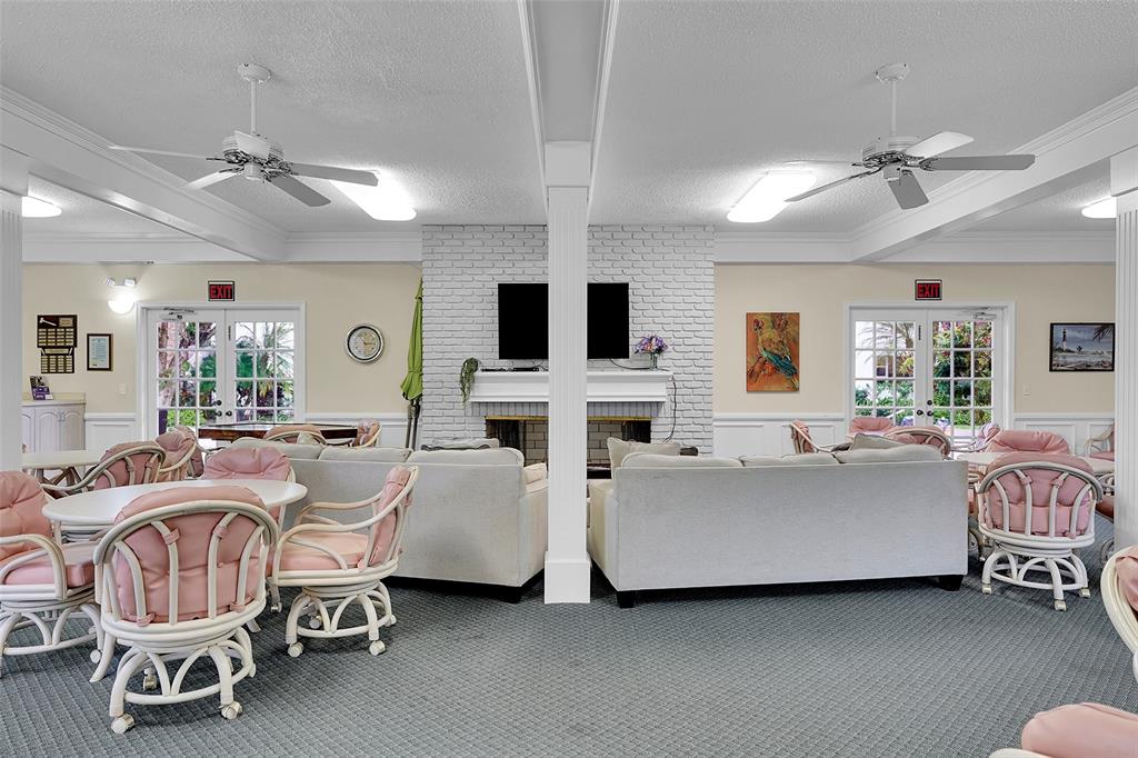 330 South Cypress Road, Unit 610 Pompano Beach, FL 33060 - Photo 24 of 35 a living room with furniture and a flat screen tv