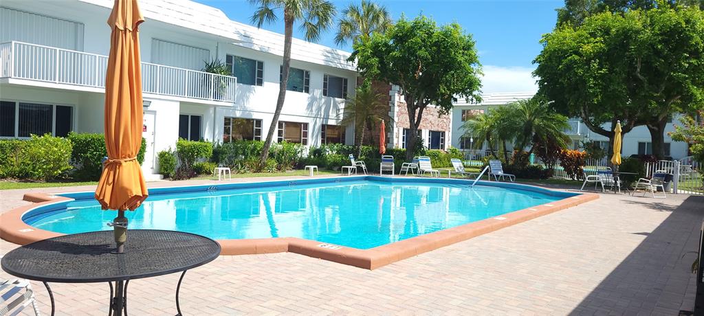 330 South Cypress Road, Unit 610 Pompano Beach, FL 33060 - Photo 26 of 35 a view of a swimming pool with a lounge chair