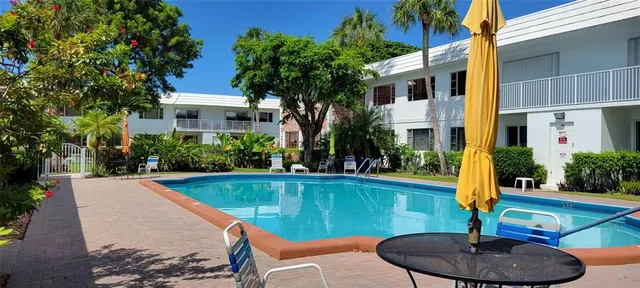 a swimming pool with outdoor seating and yard