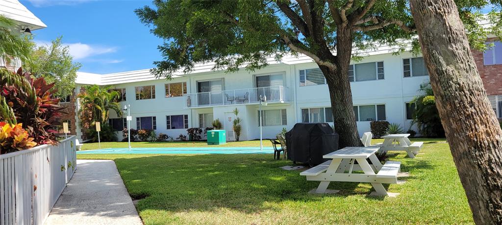 330 South Cypress Road, Unit 610 Pompano Beach, FL 33060 - Photo 30 of 35 a front view of a house with a yard table and chairs