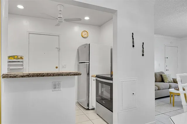a kitchen with stainless steel appliances granite countertop a refrigerator and a sink