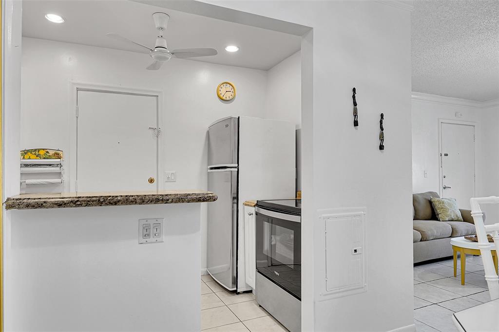 330 South Cypress Road, Unit 610 Pompano Beach, FL 33060 - Photo 3 of 35 a kitchen with stainless steel appliances granite countertop a refrigerator and a sink