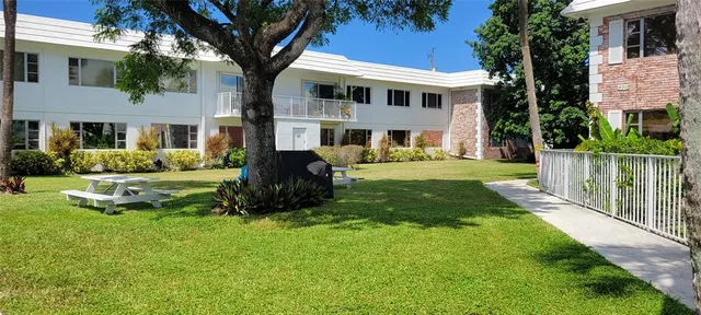 a front view of a house with a yard table and chairs