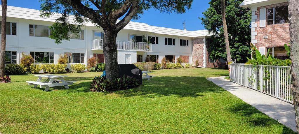 330 South Cypress Road, Unit 610 Pompano Beach, FL 33060 - Photo 31 of 35 a front view of a house with a yard table and chairs