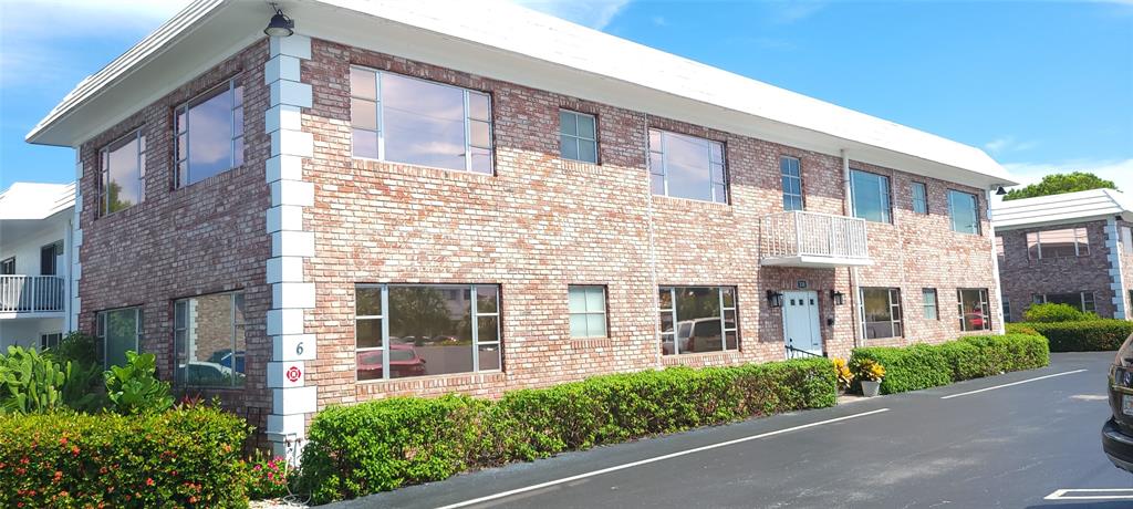 330 South Cypress Road, Unit 610 Pompano Beach, FL 33060 - Photo 32 of 35 front view of a brick house with a large windows