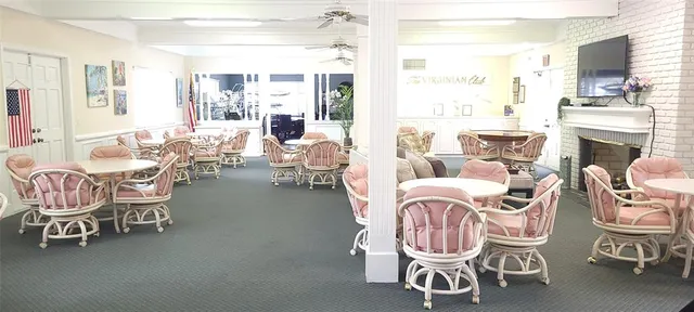 a living room with furniture a fireplace and a large window