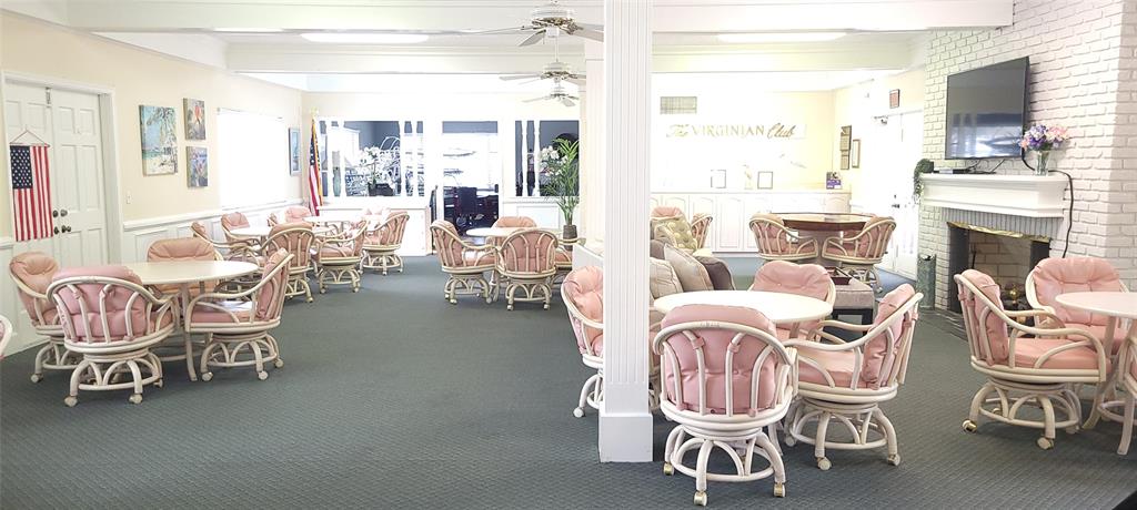 330 South Cypress Road, Unit 610 Pompano Beach, FL 33060 - Photo 33 of 35 a living room with furniture a fireplace and a large window