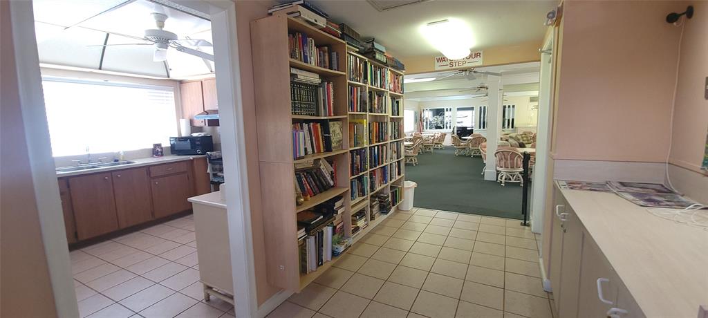 330 South Cypress Road, Unit 610 Pompano Beach, FL 33060 - Photo 35 of 35 a hallway with a sink and cabinets