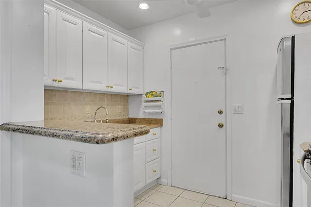 a kitchen with white cabinets