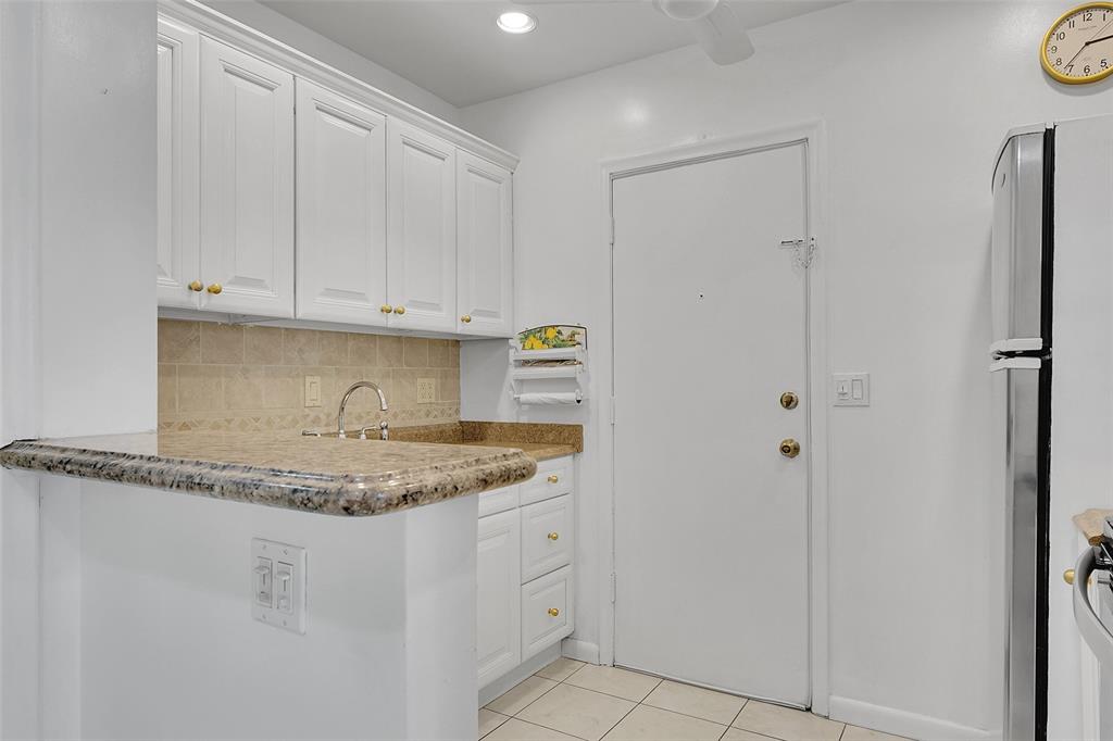 330 South Cypress Road, Unit 610 Pompano Beach, FL 33060 - Photo 5 of 35 a kitchen with white cabinets