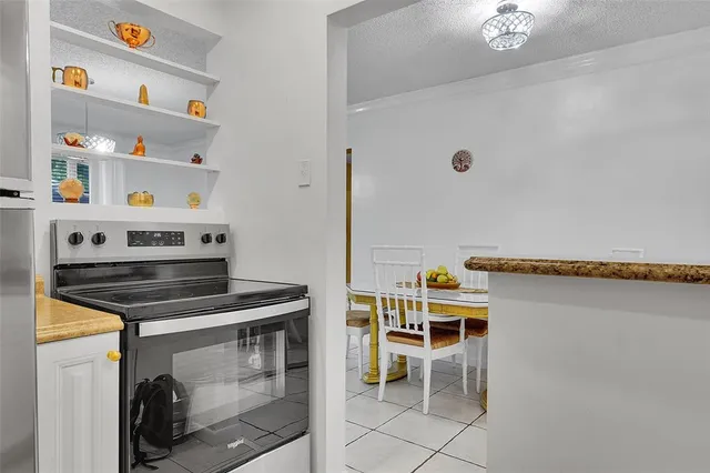 a kitchen with stainless steel appliances granite countertop a stove and a cabinets