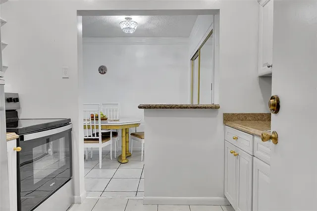 a view of a kitchen with fridge and stove