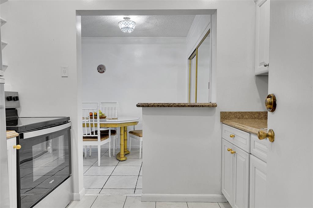 330 South Cypress Road, Unit 610 Pompano Beach, FL 33060 - Photo 9 of 35 a view of a kitchen with fridge and stove