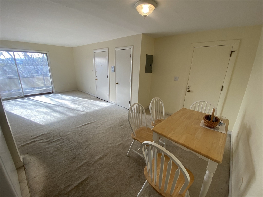 64 Jacqueline Road, Unit 11 Waltham, MA 02452 - Photo 10 of 17 a bedroom with a bed and a dresser
