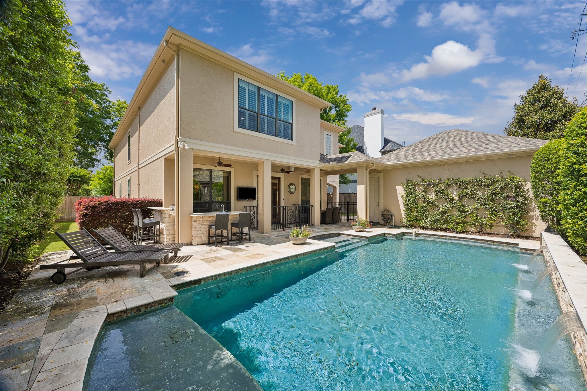 802 Anderson Street Bellaire, TX 77401 - Photo 3 of 36 The pool is so inviting with its tranquil water feature and multiple locations to sit and relax.