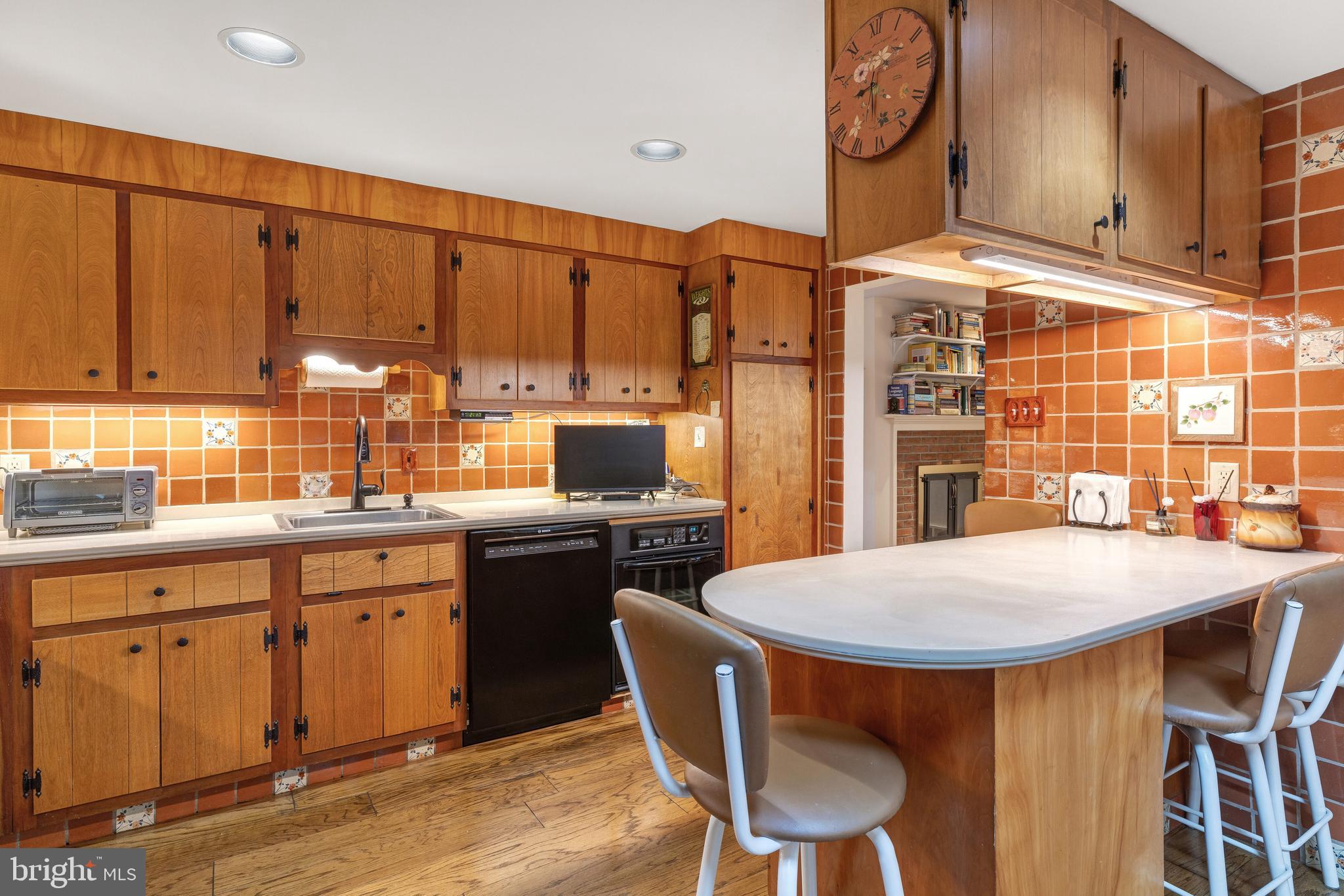 2390 Terwood Road Huntingdon Valley, PA 19006 - Photo 13 of 36 a kitchen with stainless steel appliances a dining table chairs and wooden cabinets