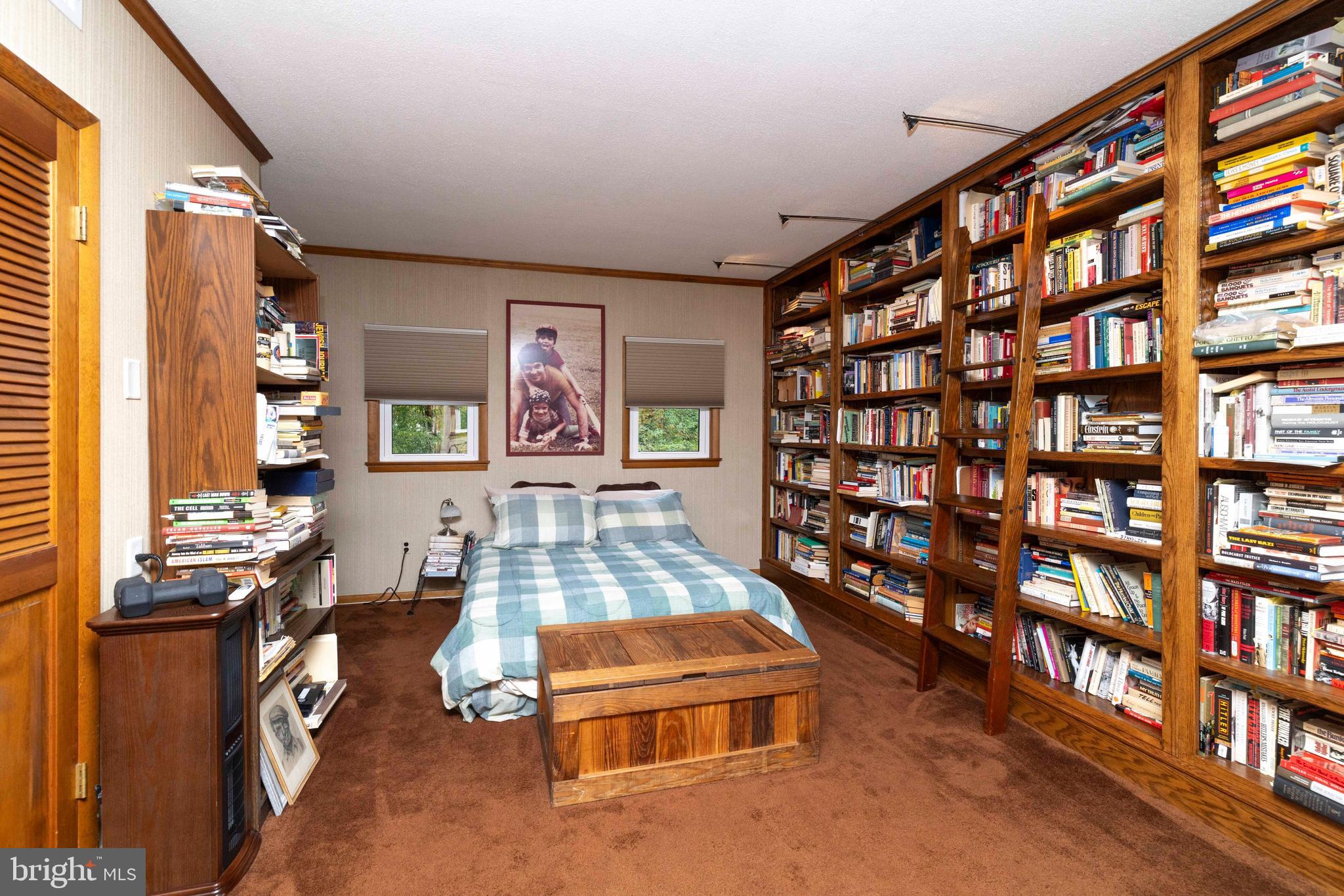 2390 Terwood Road Huntingdon Valley, PA 19006 - Photo 26 of 36 a living room with lots of furniture and a book shelf