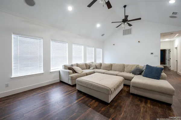 a living room with furniture and a wooden floor