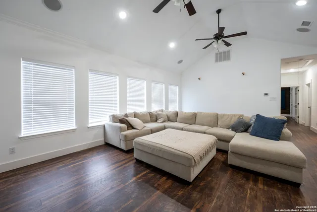 a living room with furniture and a wooden floor