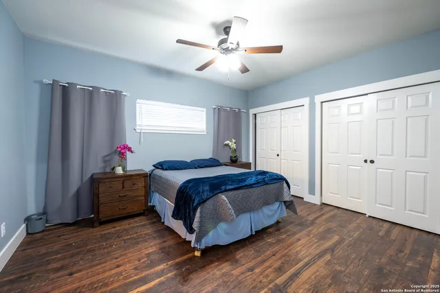 a spacious bedroom with a bed and a chandelier