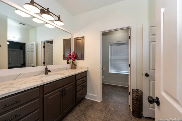 a bathroom with a double vanity sink and a mirror