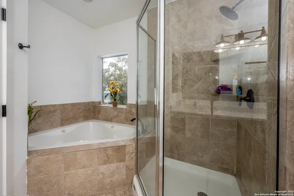 a bathroom with a bathtub and shower