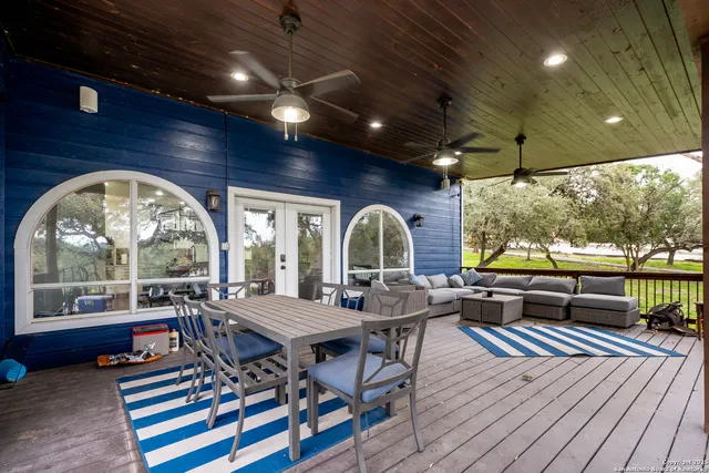 a living room with furniture a wooden floor and a large window