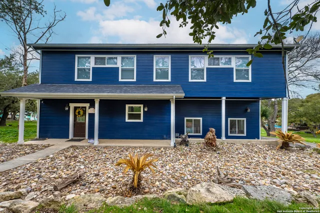 a front view of a building with a garden