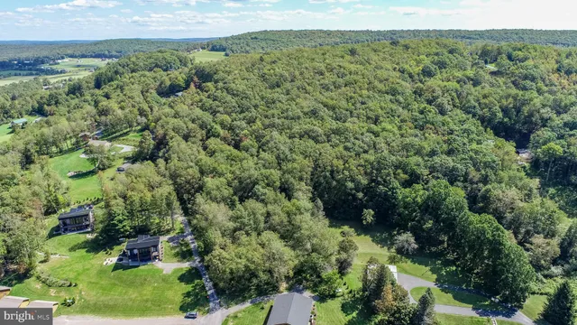 an aerial view of a houses with a yard