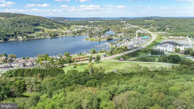 an aerial view of residential houses with outdoor space and river