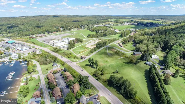 an aerial view of residential houses with outdoor space and swimming pool
