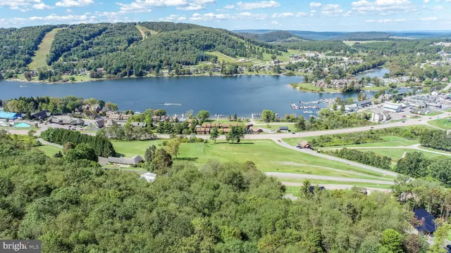 an aerial view of a houses with outdoor space and lake view