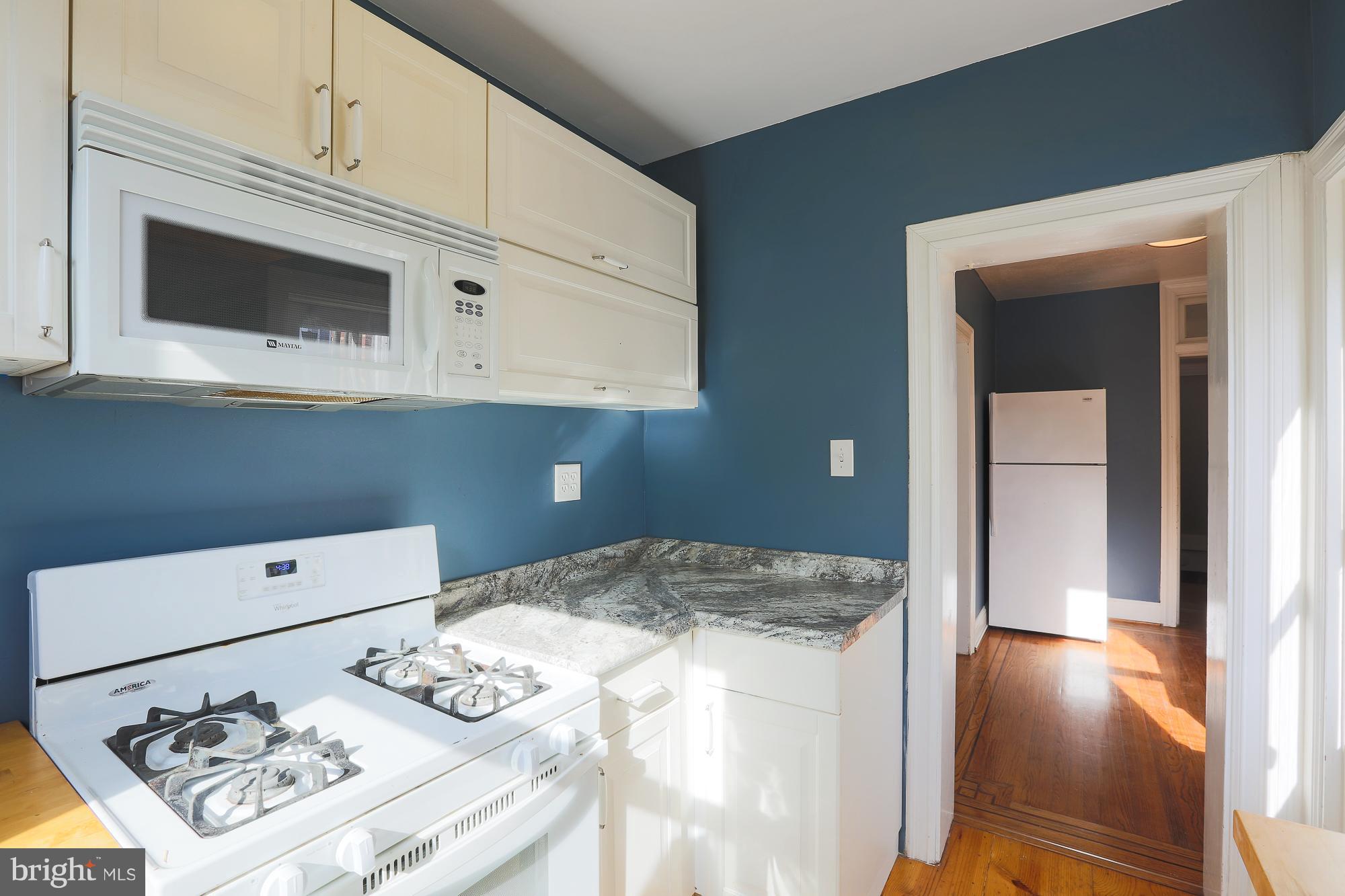 3628 Rexmere Road Baltimore, MD 21218 - Photo 17 of 28 a kitchen with a stove and a microwave