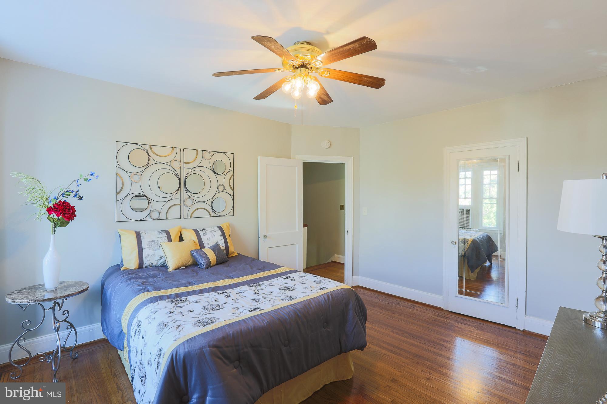 3628 Rexmere Road Baltimore, MD 21218 - Photo 18 of 28 a bedroom with a large bed and a chandelier