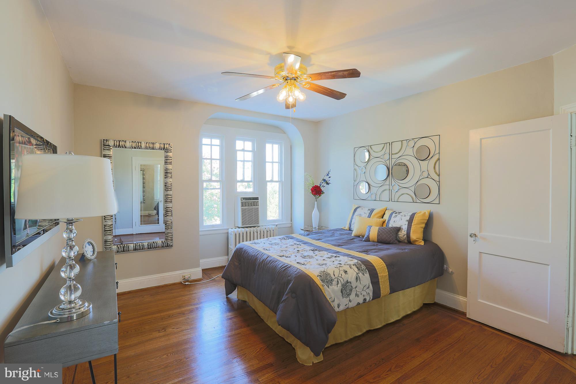 3628 Rexmere Road Baltimore, MD 21218 - Photo 19 of 28 a bedroom with a bed and wooden floor