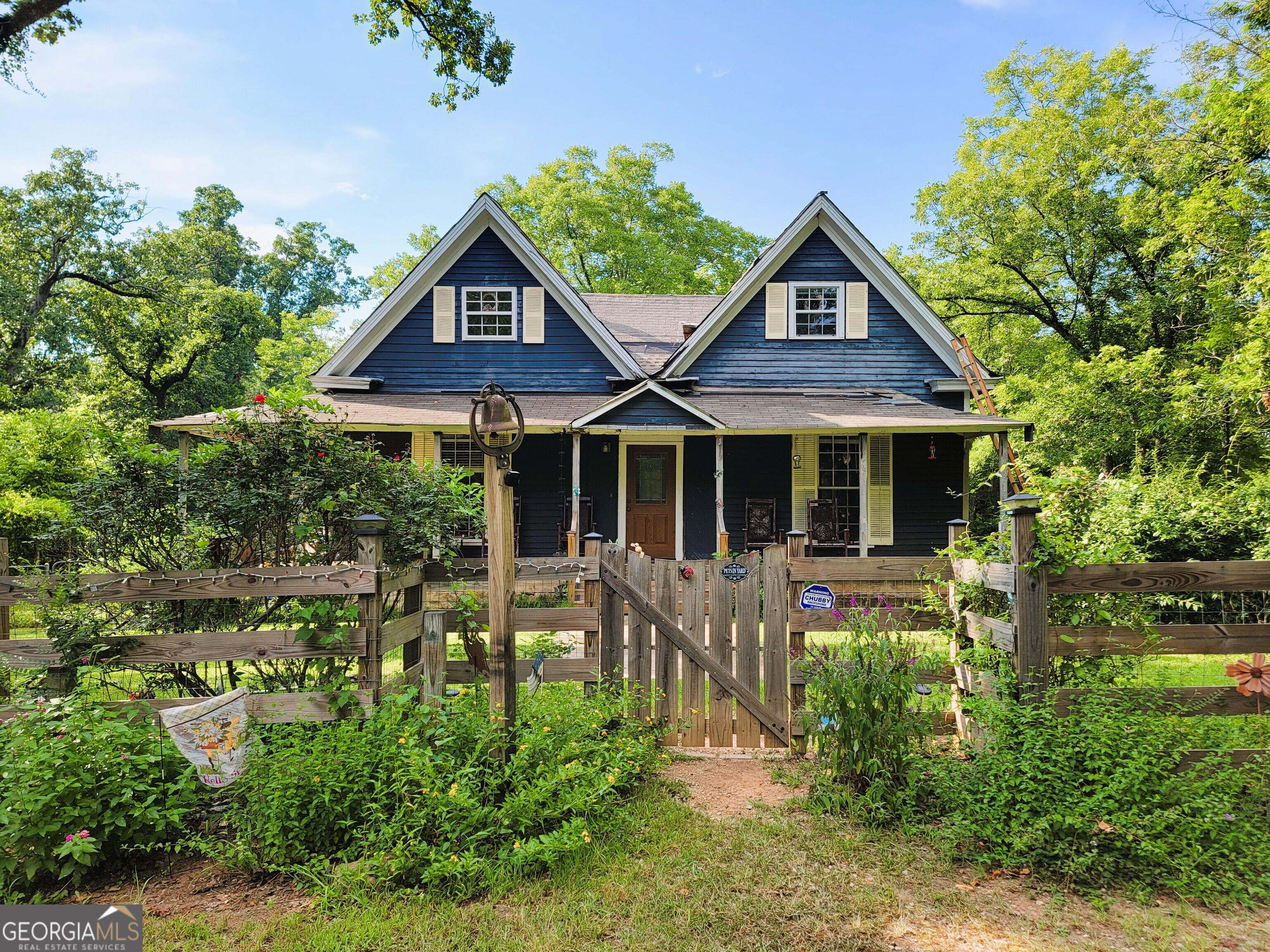 a front view of a house with a yard table and chairs