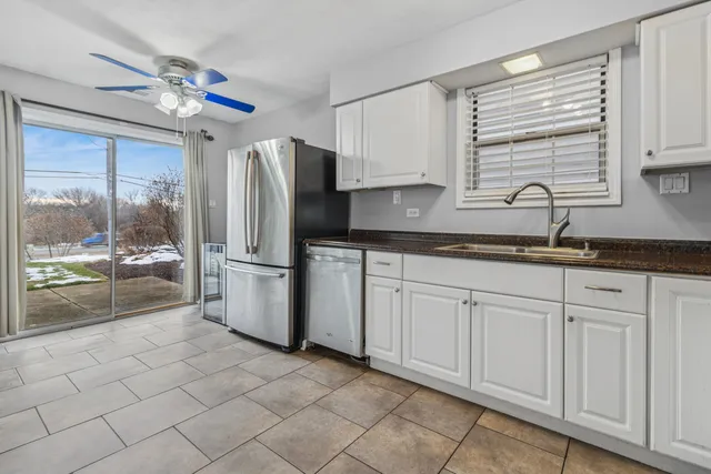 a kitchen with stainless steel appliances granite countertop a refrigerator sink and cabinets
