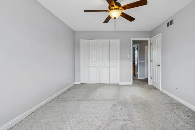 an empty room and chandelier fan