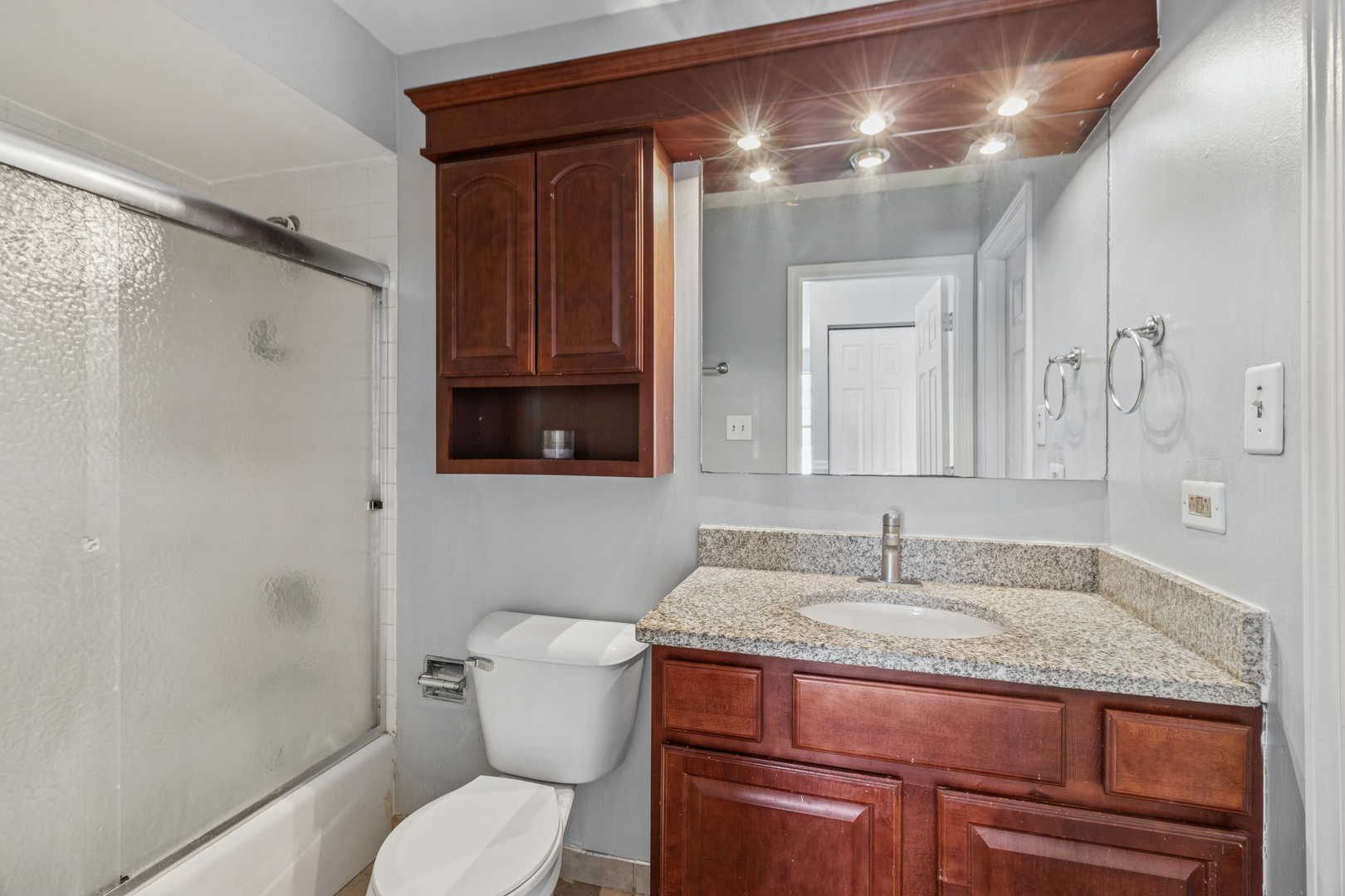 8313 High Point Circle, Unit F Darien, IL 60561 - Photo 16 of 20 a bathroom with a granite countertop sink toilet and shower
