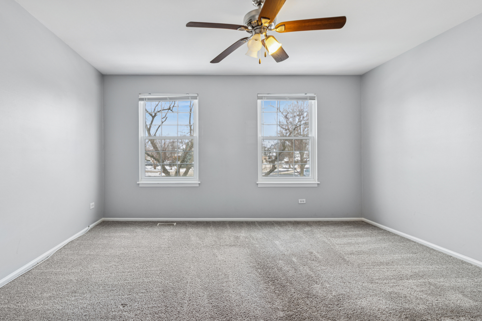 8313 High Point Circle, Unit F Darien, IL 60561 - Photo 18 of 20 an empty room with windows and fan