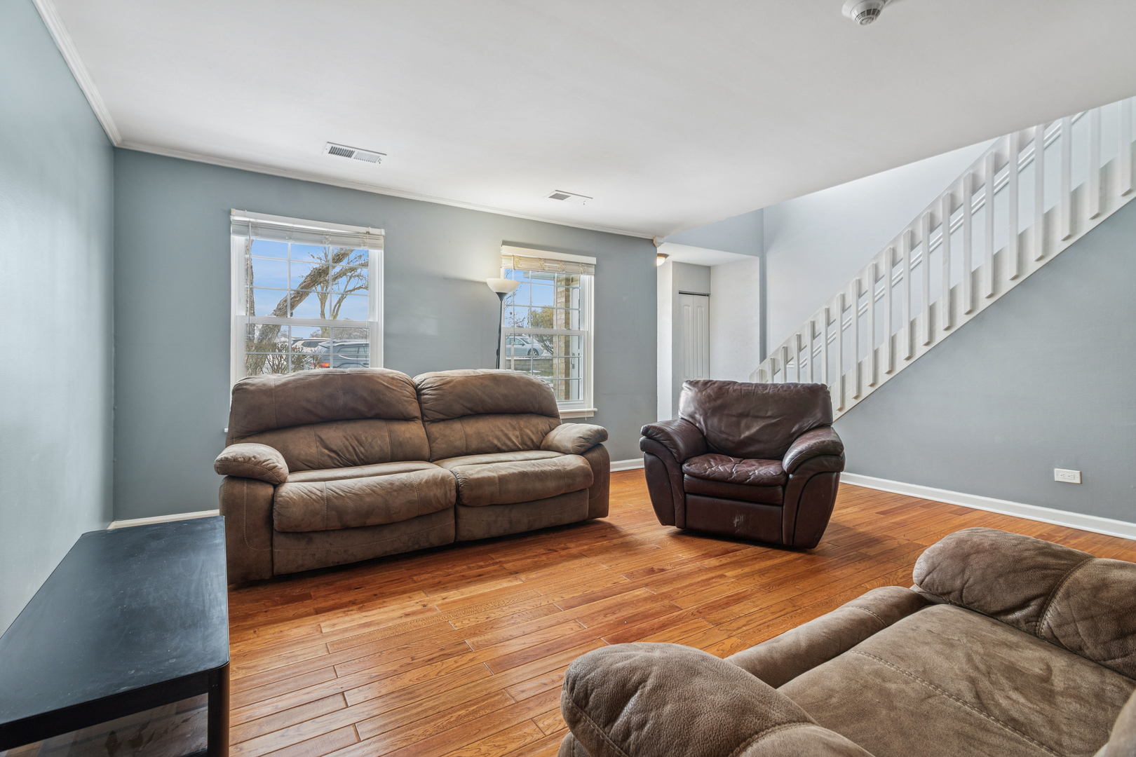 8313 High Point Circle, Unit F Darien, IL 60561 - Photo 6 of 20 a living room with furniture and a wooden floor