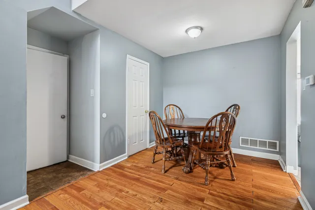a view of a dining room with furniture and wooden floor