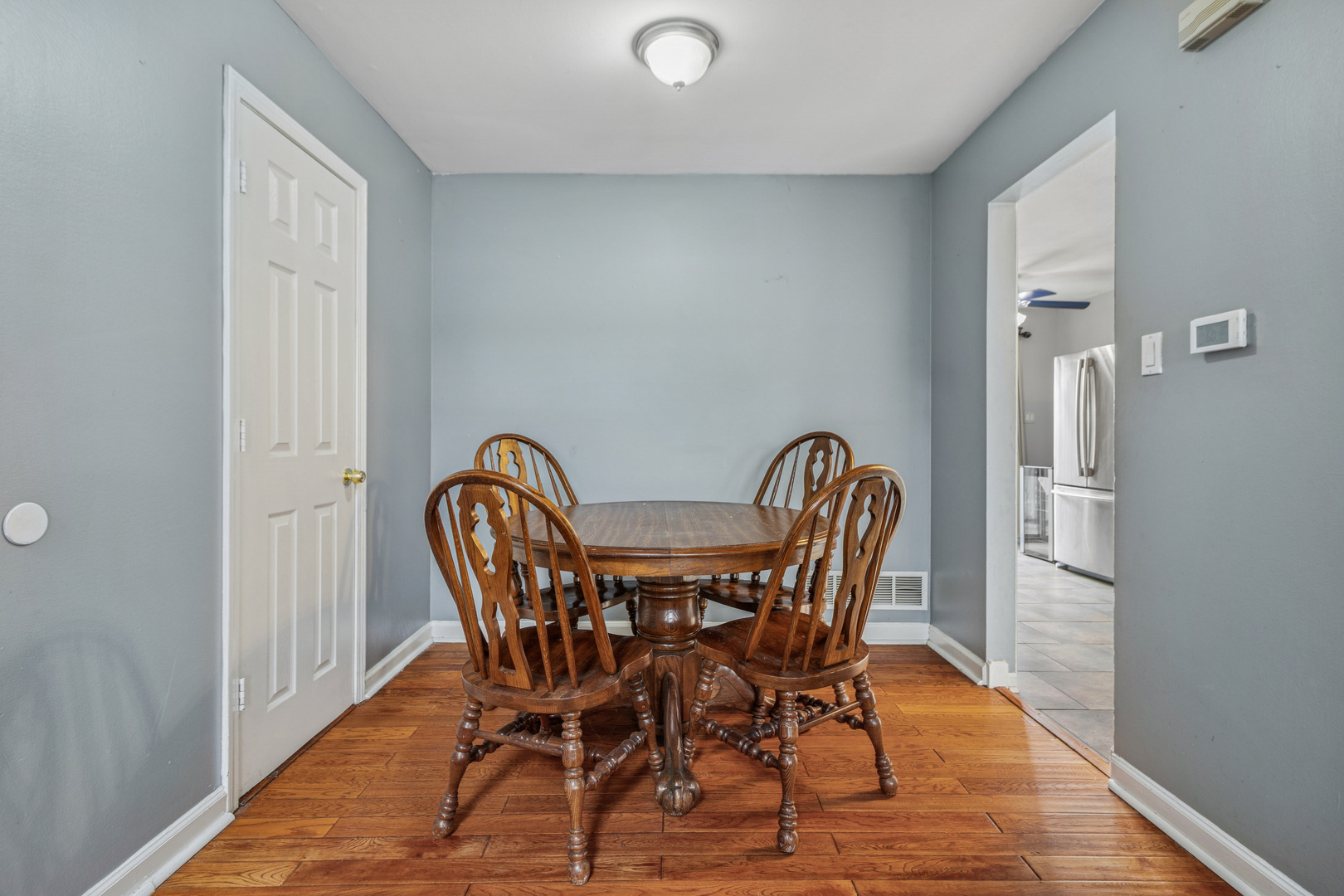 8313 High Point Circle, Unit F Darien, IL 60561 - Photo 10 of 20 a view of a dining room with furniture and wooden floor