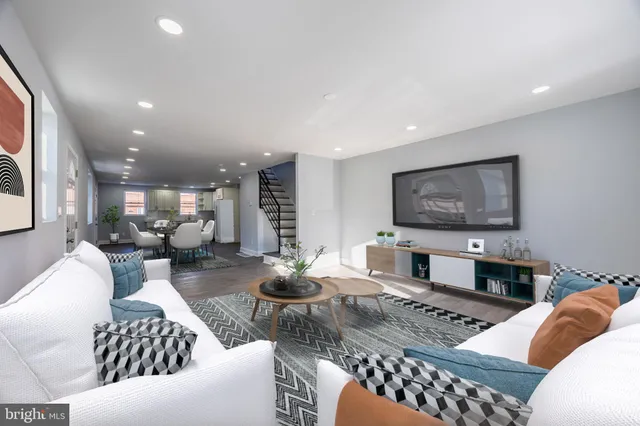 a living room with furniture and a flat screen tv